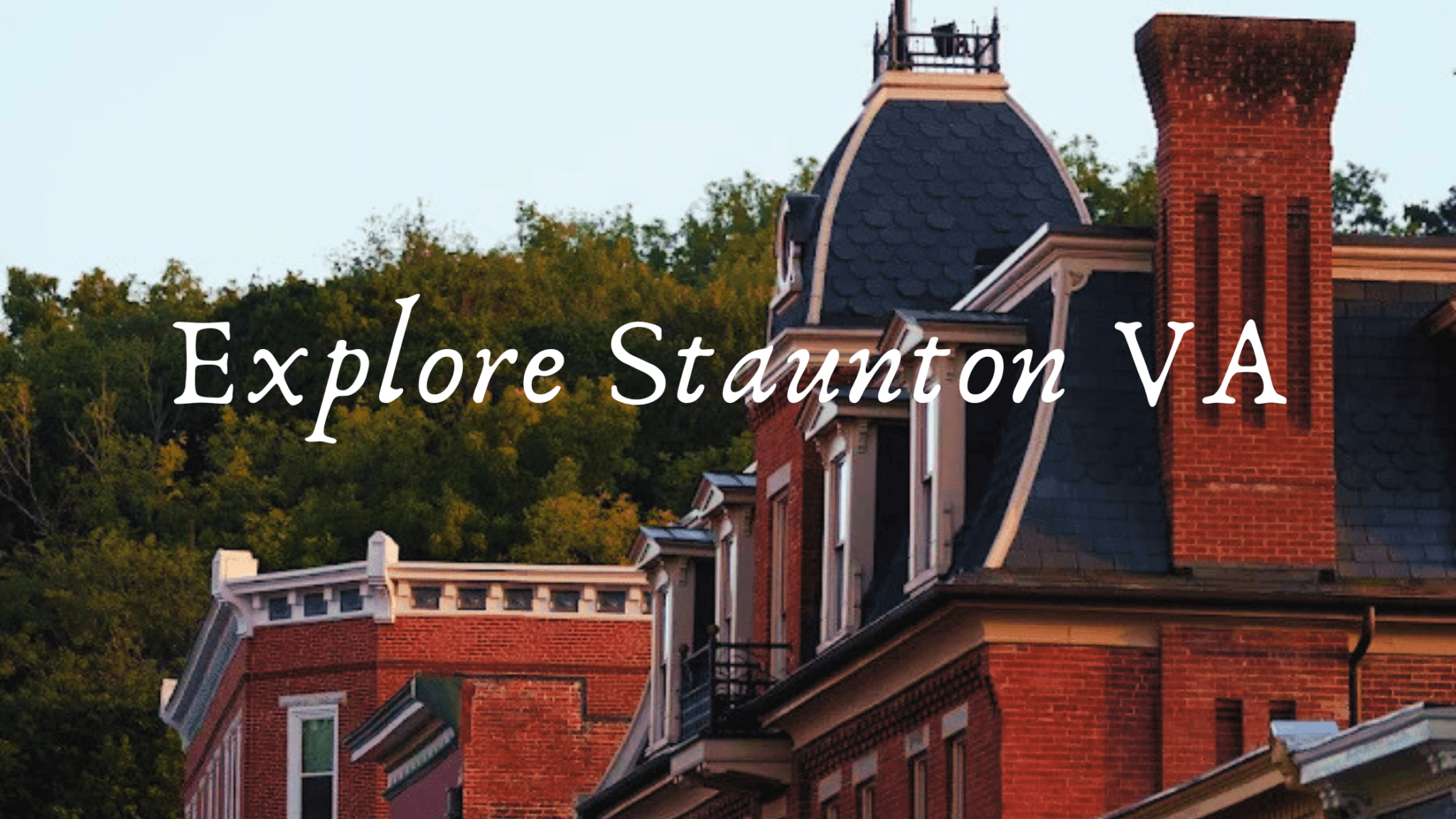 Text overlaying a photo of historic buildings against a green hillside, promoting exploration of Staunton, Virginia.