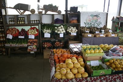 A vibrant display of fresh fruits and vegetables at a market booth.