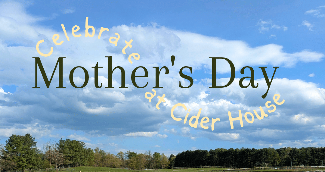 Promotional banner reading 'Celebrate Mother's Day at Cider House' curved in pale yellow over a blue sky with clouds and a green field below