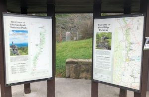 Two large national park signs showing trails and various points of interest